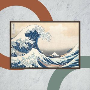 Framed artwork of "The Great Wave off Kanagawa," depicting a large wave with Mount Fuji in the background. The background has a concrete texture with abstract colored shapes.